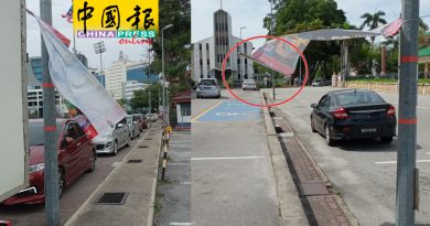 广告条幅随风飘扬    民众担心砸中人车