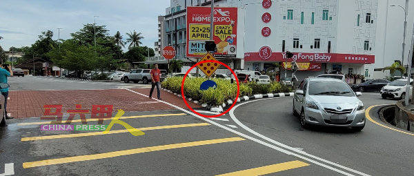 路口安全岛分界指示牌（红圈）被花树阻挡，一些来自雅佳美浪路的外州车辆一时不察，误驶入右转的反方向车道（图右）。
