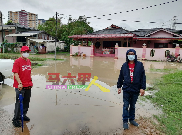 ■刘志俍（右起）和助理李祥生巡视遭遇水灾的三芭弄。