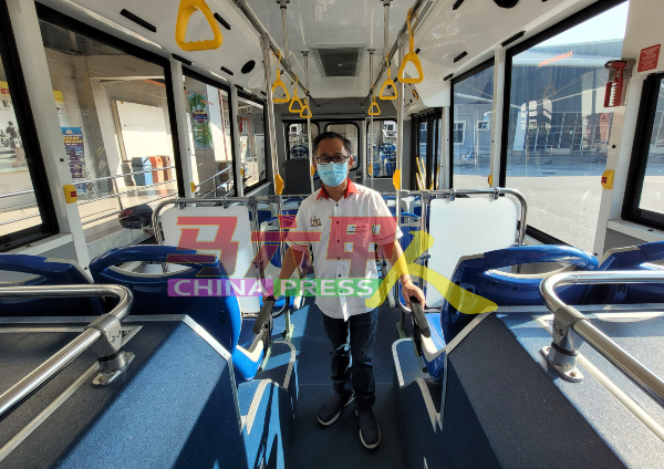刘志俍参观宽敞的巴士前部，该处具冷气设备。