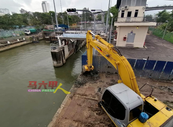 水利灌溉局承包商使用坭机，挖掘马六甲河床泥泞。