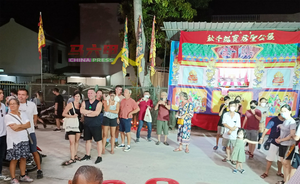 不少国内外游客围观布袋戏演出。