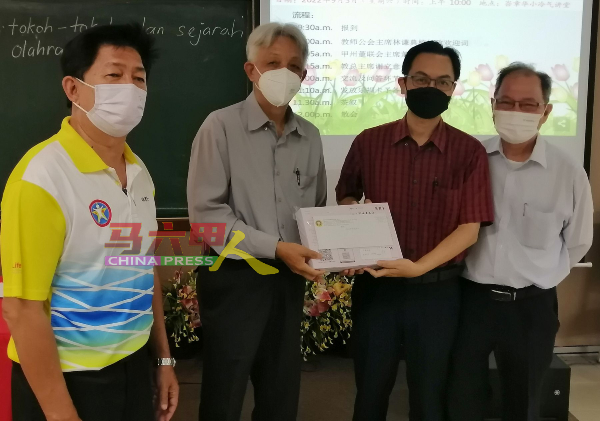 ■谢立意（左2起）移交乐捐卡给平民学校校长熊章圣，左起林谦典及萧汉昌。