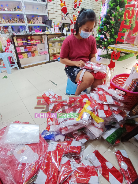 安洋有限公司职员忙着为圣诞节帽子进行包装上市。