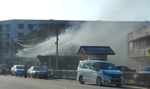 ■甘榜拉班美食中心的其中一摊档无故失火，从远处可看到冒出浓烟。
