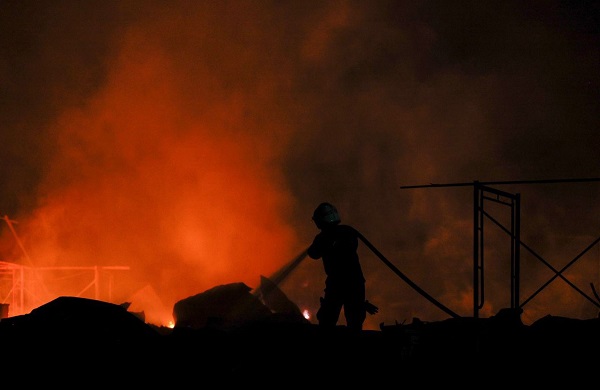 消拯员奋力扑灭火势，住着约100名建筑工友的劳工宿舍，被大火烧毁约95%。
