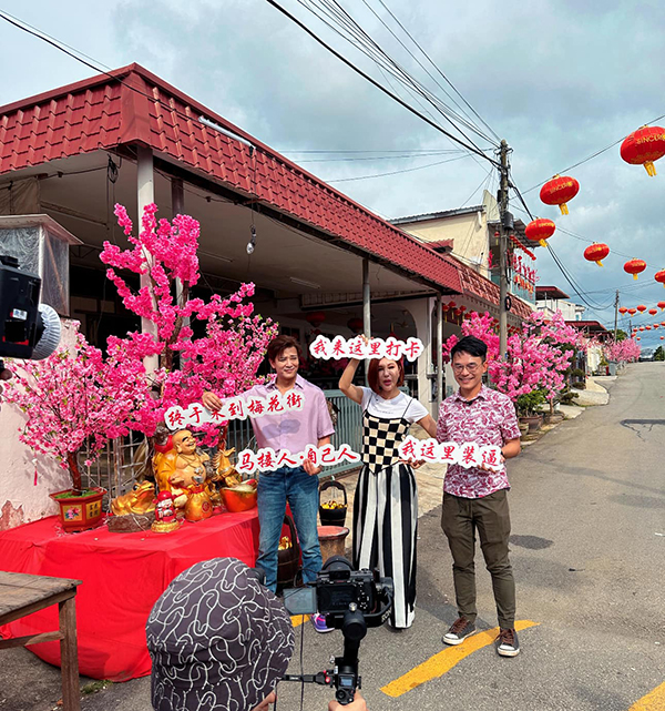 赖家濠（右起）、利菁及陈晓东，到梅花街年景布置拍照打卡。