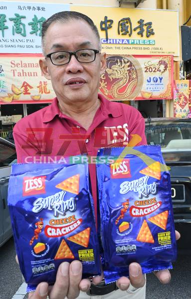吴炜江展示东方食品有限公司推出火红的Super Ring芝士口味饼乾。