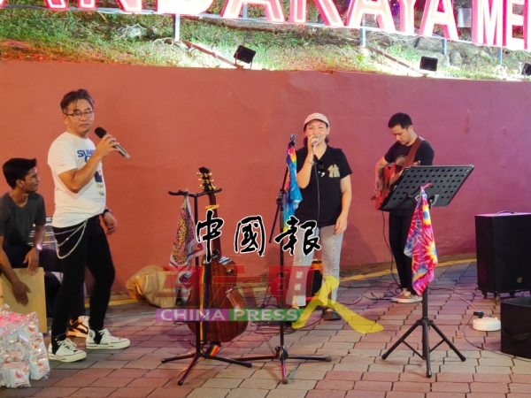 独立乐团成员在街头投入弹唱。