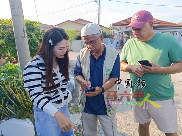 林朝雁（左）与村民向大马土地测量与图测局（JUPEM）的测量师了解详情。