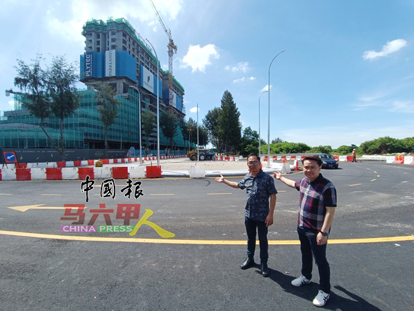 郑凯伦（右）与刘志俍（左）到哥打拉沙马那交通圈，了解新路的工程进展。