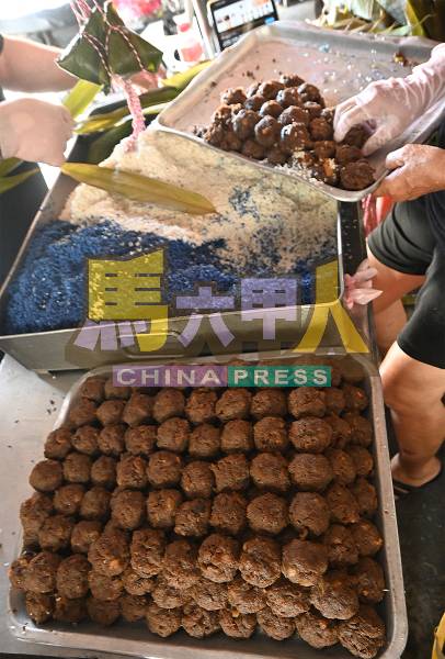 陈桂莲把娘惹粽的馅料及染上蓝花的糯米准备好,就开始动手裹粽子。