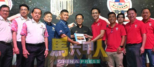 赖志辉(右5起)在刘志俍见证下,移交文件给周志明。