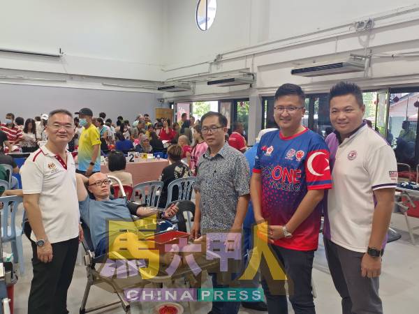 邱培栋（左）与许文华（右起）、谢守钦及刘志俍给予捐血者精神上的鼓励。