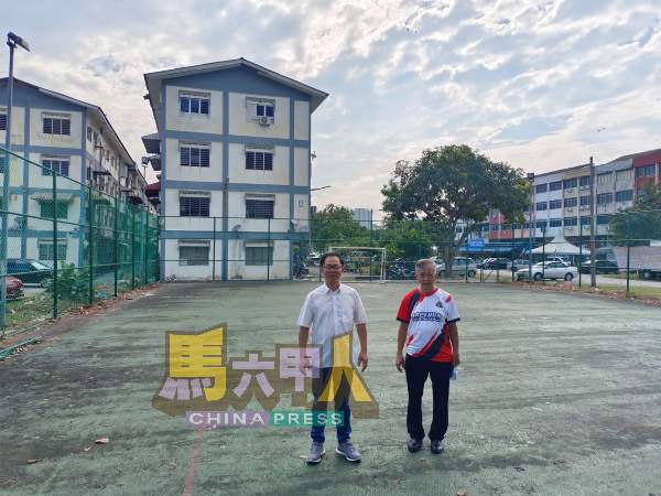 刘志俍(左起)与陈劲源巡视维修球场的工程进展。